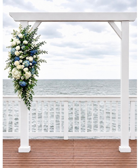Wedding centerpiece with peach roses, delphinium, Queen Anne’s lace, and eucalyptus. Available in petite or full size.