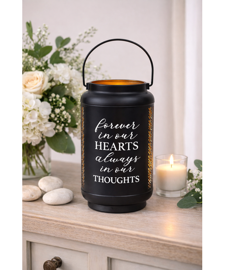 Black sympathy lantern with engraved remembrance quote and flameless LED candle, suitable for indoor or outdoor display.