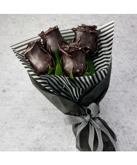 Wrapped bouquet of 4 or 8 chocolate-scented wax roses. Long-lasting, non-edible. Option to add 8 Wockenfuss truffles.