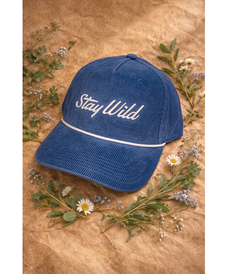 A corduroy hat with an embroidered ‘Stay Wild’ logo, white rope detail, and adjustable strap. Available in four colors.