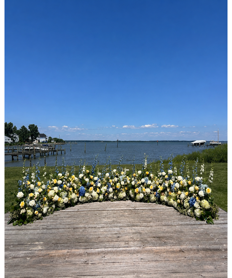 Wedding ceremony flowers featuring white, blue, and yellow blooms for arches, aisles, welcome signs, and floral installations.