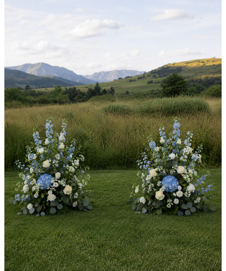 Wedding centerpiece with peach roses, delphinium, Queen Anne’s lace, and eucalyptus. Available in petite or full size.