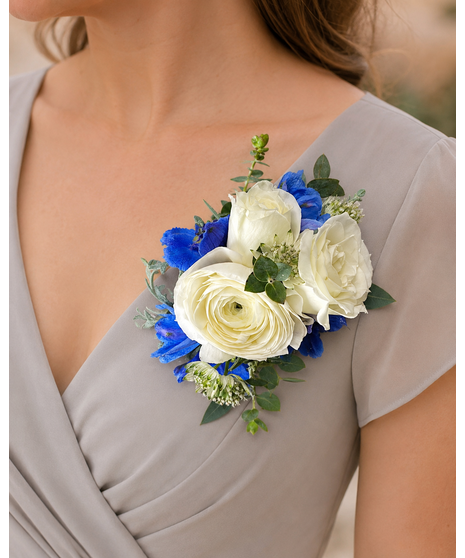 Soft blue and white wedding corsage with greenery, available in wrist or chest pin-on styles.