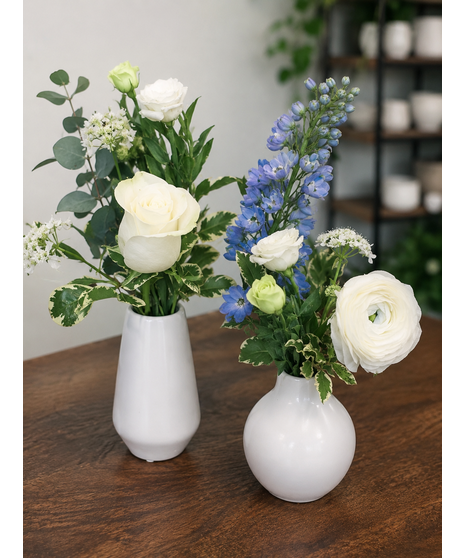 Wedding centerpiece with peach roses, delphinium, Queen Anne’s lace, and eucalyptus. Available in petite or full size.