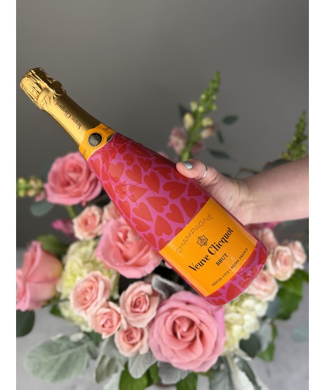 Red rose bouquet paired with wine or champagne and boxed dessert truffles, styled as a romantic gift set.