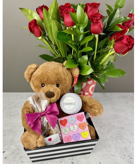 Plush teddy bear paired with gourmet caramels, shower steamer, and a Volcano-scented candle.