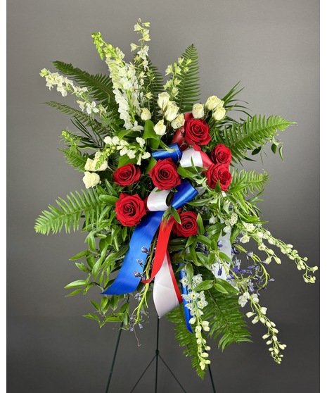 Standing spray of red, white, and blue flowers. Comes in four sizes with optional ribbon script for personalization.