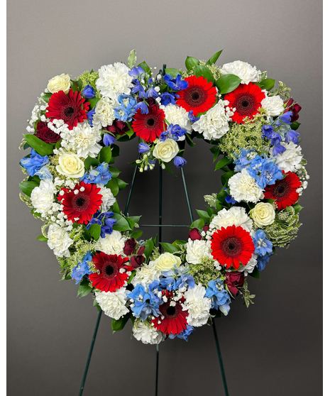 Heart-shaped red, white & blue floral wreath on an easel. Available in 12