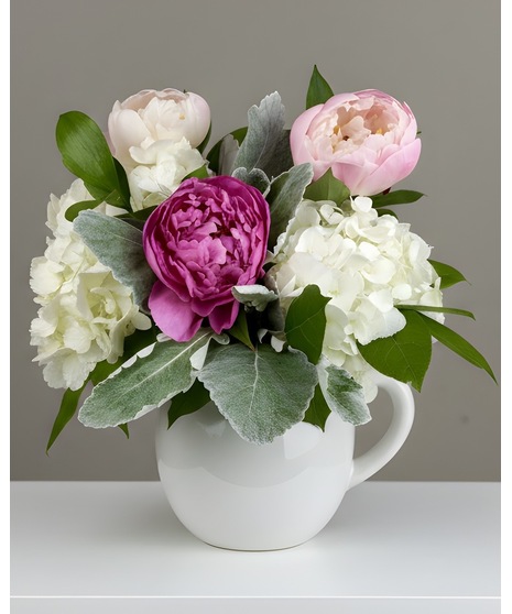 Blush peonies with white hydrangea and fresh greenery in a vase, available in 4 sizes.
