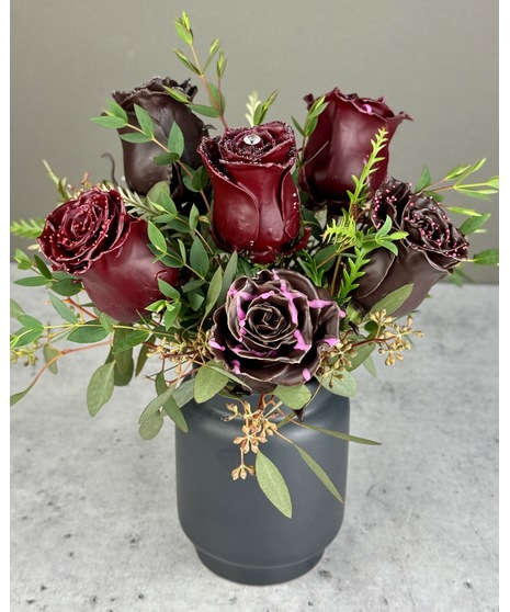 Arrangement of six chocolate-scented wax-dipped roses in a black vase. Non-edible; upgrade available with Wockenfuss truffles.