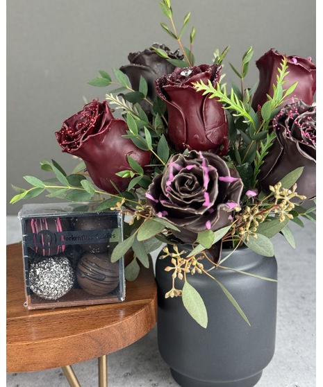 Arrangement of six chocolate-scented wax-dipped roses in a black vase. Non-edible; upgrade available with Wockenfuss truffles.