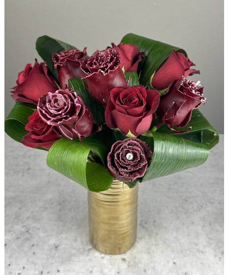 Arrangement of real and wax-dipped chocolate-scented red roses in a gold vase. Non-edible. Available in 12, 18, or 24 roses.