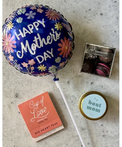 Tiered gift set with treats, spa items, balloon, and optional wine or champagne.