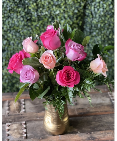 shades of pink, lavender, and cream roses in short gold-toned vase