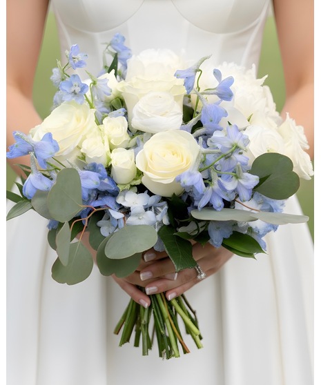 Soft blue and white bridal bouquet with roses, hydrangea, delphinium, and greenery in a romantic coastal style. Available in 3 sizes.