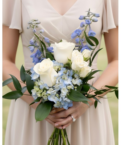 Soft blue and white wedding flowers for bridal party members, including bouquets, flower girl petals, and presentation stems.