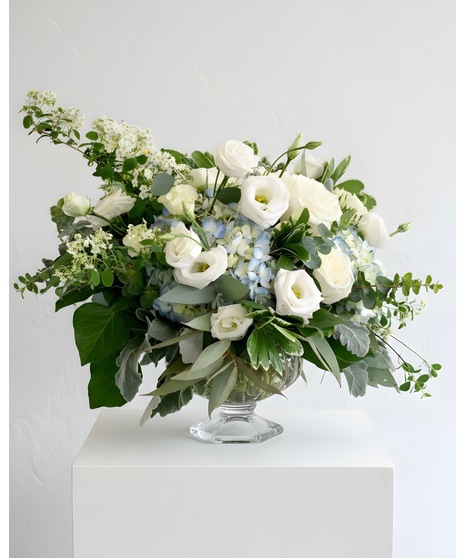 Wedding centerpiece with peach roses, delphinium, Queen Anne’s lace, and eucalyptus. Available in petite or full size.