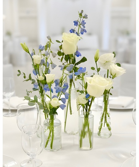 Wedding centerpiece with peach roses, delphinium, Queen Anne’s lace, and eucalyptus. Available in petite or full size.