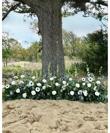 Wedding centerpiece with peach roses, delphinium, Queen Anne’s lace, and eucalyptus. Available in petite or full size.