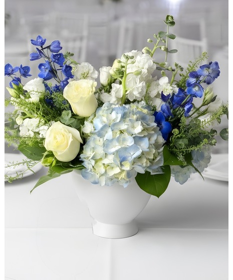 Wedding centerpiece with peach roses, delphinium, Queen Anne’s lace, and eucalyptus. Available in petite or full size.