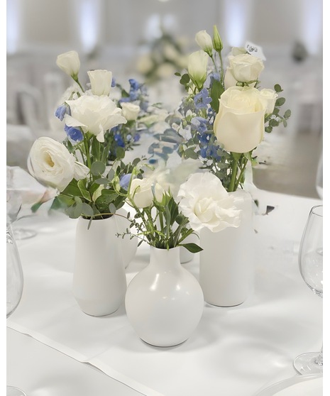 Wedding centerpiece with peach roses, delphinium, Queen Anne’s lace, and eucalyptus. Available in petite or full size.