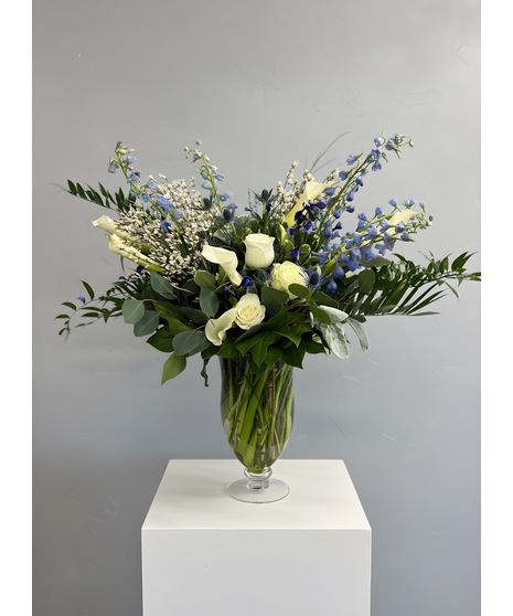 Wedding centerpiece with peach roses, delphinium, Queen Anne’s lace, and eucalyptus. Available in petite or full size.
