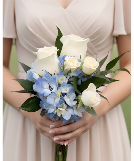 Soft blue and white wedding flowers for bridal party members, including bouquets, flower girl petals, and presentation stems.
