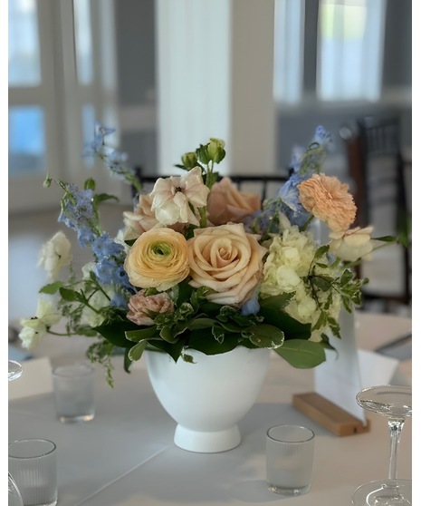 Wedding centerpiece with peach roses, delphinium, Queen Anne’s lace, and eucalyptus. Available in petite or full size.