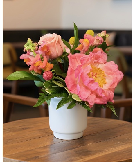 Bright citrus-inspired wedding centerpieces in orange, peach, yellow, and pink tones for dining, cocktail, and reception tables.