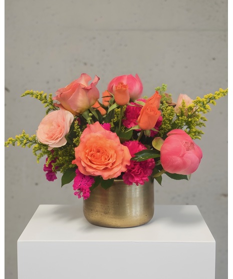 Bright citrus-inspired wedding centerpieces in orange, peach, yellow, and pink tones for dining, cocktail, and reception tables.