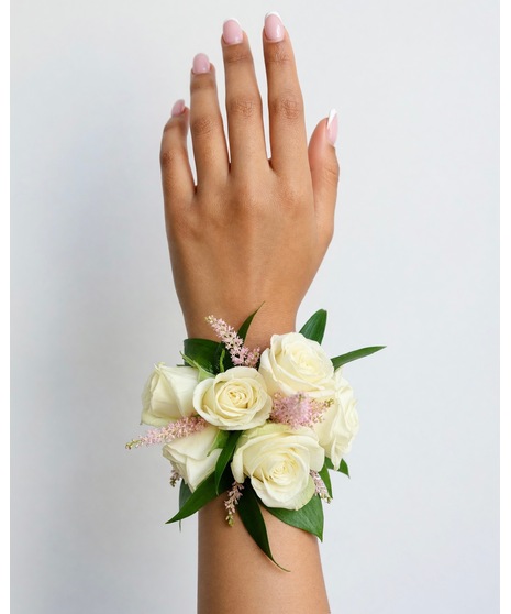 Soft blush and white wearable corsage with romantic flowers and delicate accents, available in wrist or chest style.