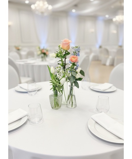 Soft peach, ivory, blush, and dusty blue wedding accent flowers with romantic garden-inspired blooms and greenery.