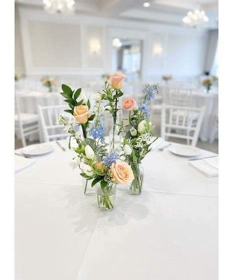 Wedding centerpiece with peach roses, delphinium, Queen Anne’s lace, and eucalyptus. Available in petite or full size.