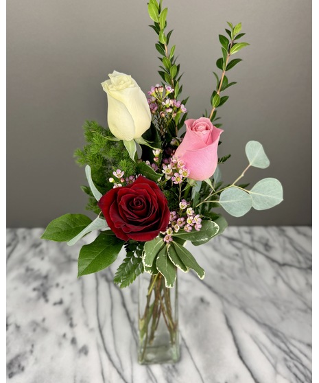 A bouquet of mixed-color roses featuring a variety of shades, including pinks, reds, and yellows. Colors may vary based on seasonal availability. Arranged for Valentine’s Day.
