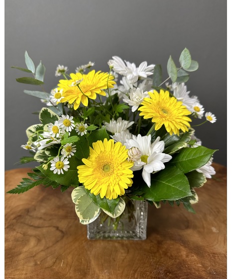 neutral flowers accented with sunshine yellow daisies in square block for new baby.