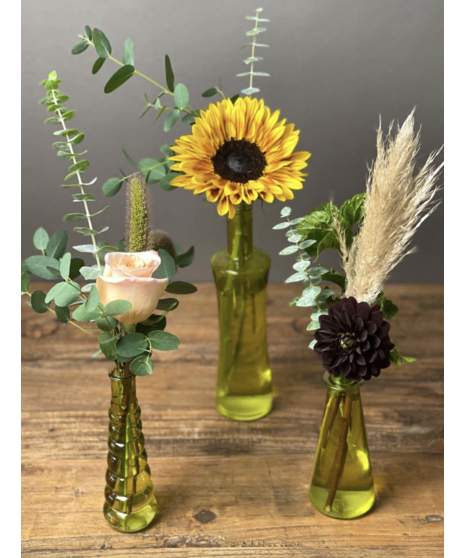 Fall flower arrangement with sunflowers, roses, burgundy accents, and rustic greenery.