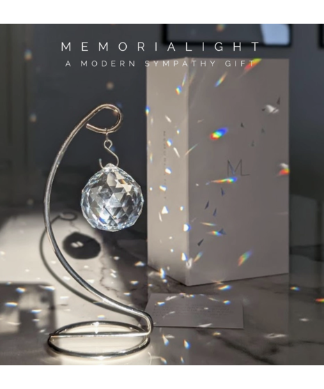 Crystal Memorialight on silver stand casts rainbow prisms in sunlight, a meaningful modern sympathy keepsake.