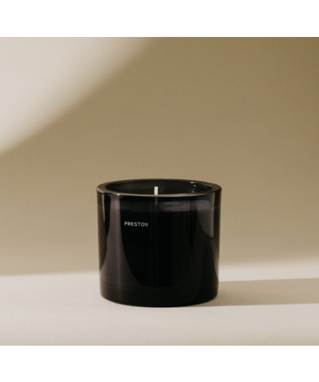 Black glass men’s cologne bottle with minimalist labeling, available in multiple scents.