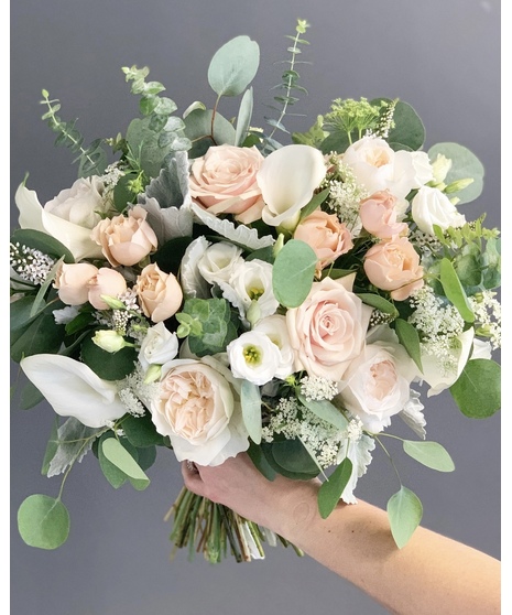 Romantic blush and ivory bridal bouquet with soft garden roses, white blooms, and airy greenery.