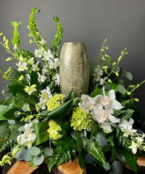 Urn or photo floral accent with mixed greenery and soft white blooms. Designed to fit your keepsake’s dimensions.