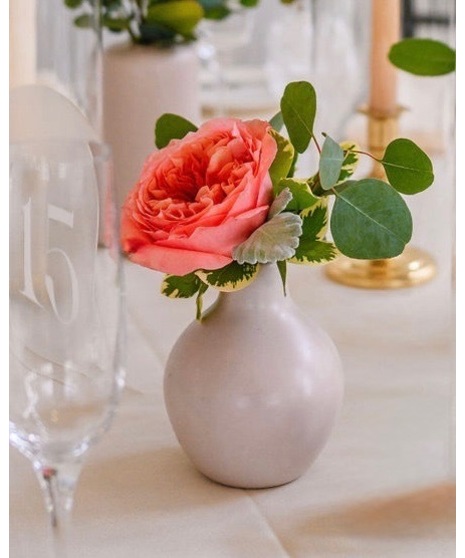 Bright citrus-inspired accent wedding flowers in orange, peach, yellow, and pink tones for cocktail tables, bars, and décor accents.