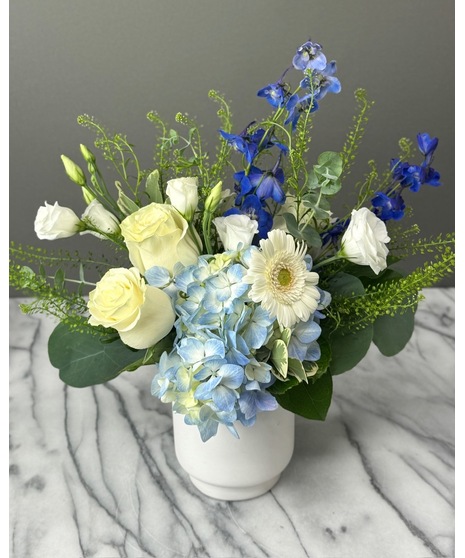 Wedding centerpiece with peach roses, delphinium, Queen Anne’s lace, and eucalyptus. Available in petite or full size.