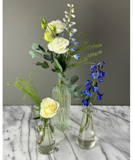 Wedding centerpiece with peach roses, delphinium, Queen Anne’s lace, and eucalyptus. Available in petite or full size.