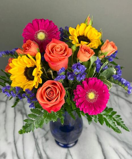 Bright, colorful arrangement of bold seasonal blooms in a vibrant designer’s mixed assortment.