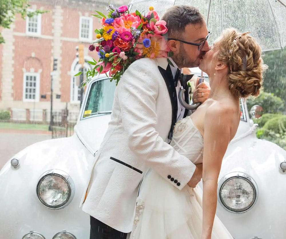 A bride and two bridesmaids flaunt their bouquets